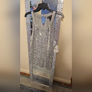 Party top size large- shinny silver. INC